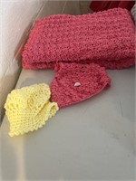 Two crocheted babies, hats and small baby blanket