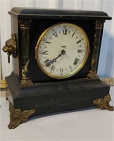 Black mantle clock with lion heads- we have the
