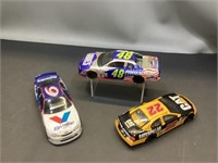 Three assorted racing car model cars