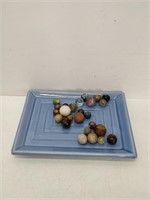 antique marbles on blue dish