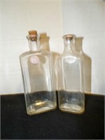 2 vintage clear glass bottles