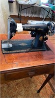 Vintage Singer sewing machine in wooden cabinet