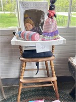 high chair and 3 dolls