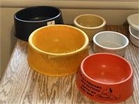 Five assorted pet food bowls