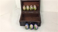 Mini brass decorated eggs in wooden box