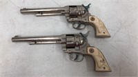 Pair of vintage metal Cowboy toy revolvers.