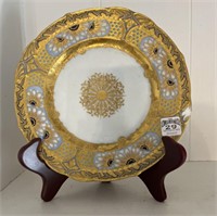Decorative plate 9.5” on stand. Chip on side.