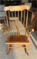 Maple spindle rocking chair with gold stenciling.