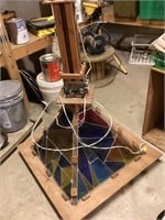A stain glass homemade chandelier that rotates