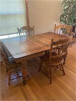 Table with 4 chairs. Appears to be oak. Table is