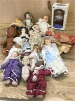Box of 9 small porcelain dolls