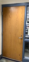 Solid commercial door with handle, kickplate