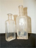 2 vintage clear glass bottles