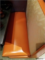 Orange/tan flower design restaurant booth seating