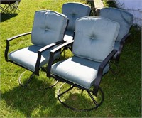 Four cast aluminum swivel arm chairs with cushions