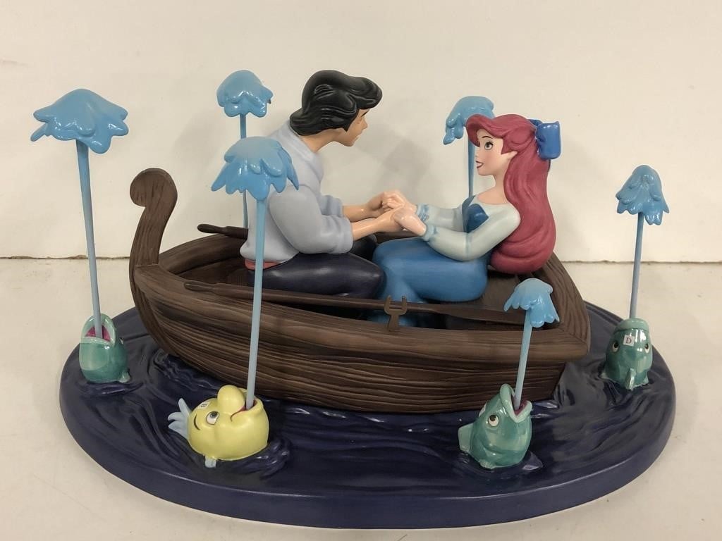 ariel and eric in boat about to kiss