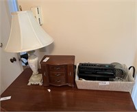 Lamp, basket and other items on top of the dresser