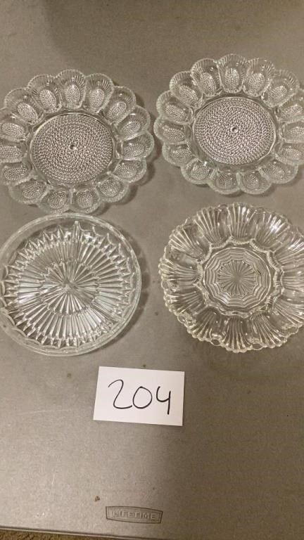 Three glass egg plates and one glass divided