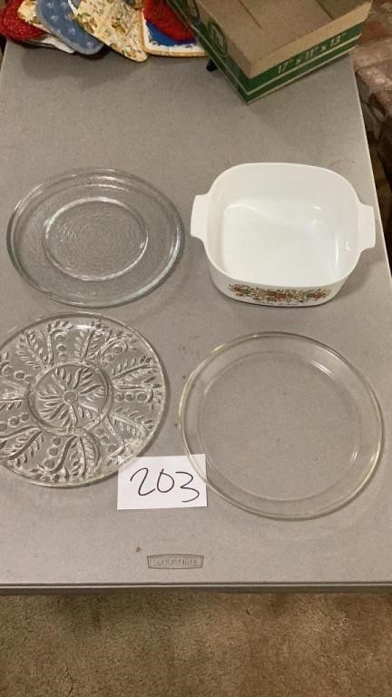 Three round glass serving trays and a corningware