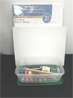 Several art paint brushes and other supplies and