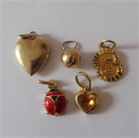 Four 9ct gold charms 3.73g with 18ct