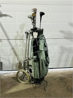 set of old golf clubs and cart