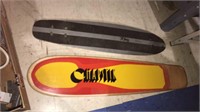 Two vintage skateboards without the wheels,