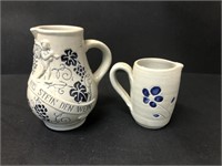 Two Pottery pitchers with glazed flowers