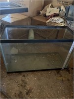 Glass aquarium. has top that is oversized. You