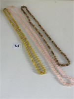 THREE STRANDS OF POLISHED STONE OR GLASS BEADED