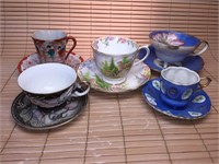 SET OF FIVE DECORATIVE CUPS AND SAUCERS