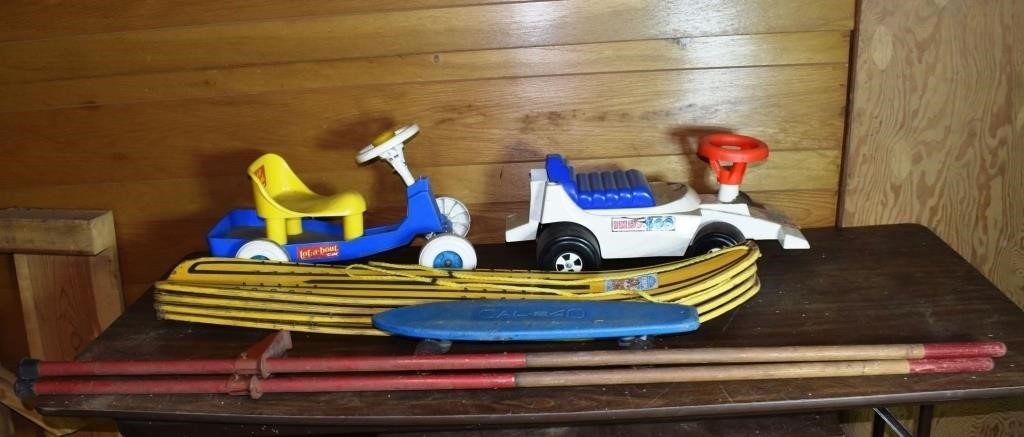 Toy lot: cars, 4 snow skis, skateboard, stilts; as