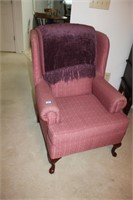 pink arm chair with throw blanket