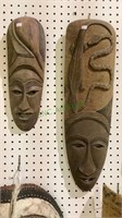 Two wooden masks - one features a snake and a
