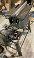 Craftsman table saw on a stand with a motor