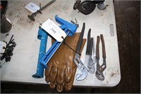gloves , pliers and caulking gun