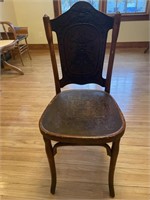 Burnt wood single chair with carved face, label