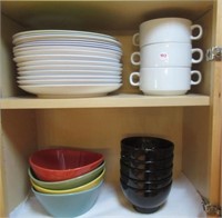 Contents of kitchen cubord that includes bowls,