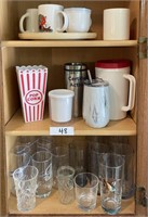 Mugs and glasses in upper kitchen cabinet