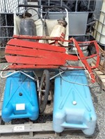 Old wooden sled, two water tanks, two sprayers,