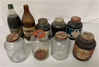 9 glass motor oil jars; 5 are full