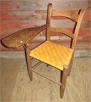 Chair with desk arm on right side featuring a