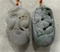 Two Carved Jade Foo Dog and Horse Pendants