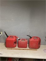 Three plastic gas cans