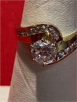 Gold tone CZ ring with white Accent stones. Size