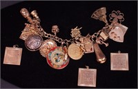 A 14K yellow gold charm bracelet and charms