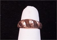 A yellow gold ring, tested 10K, with hair