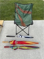 Folding chair and three umbrellas