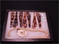 Container of jewelry: bone beaded necklace and