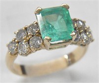 14K RING WITH LARGE EMERALD AND DIAMONDS.
